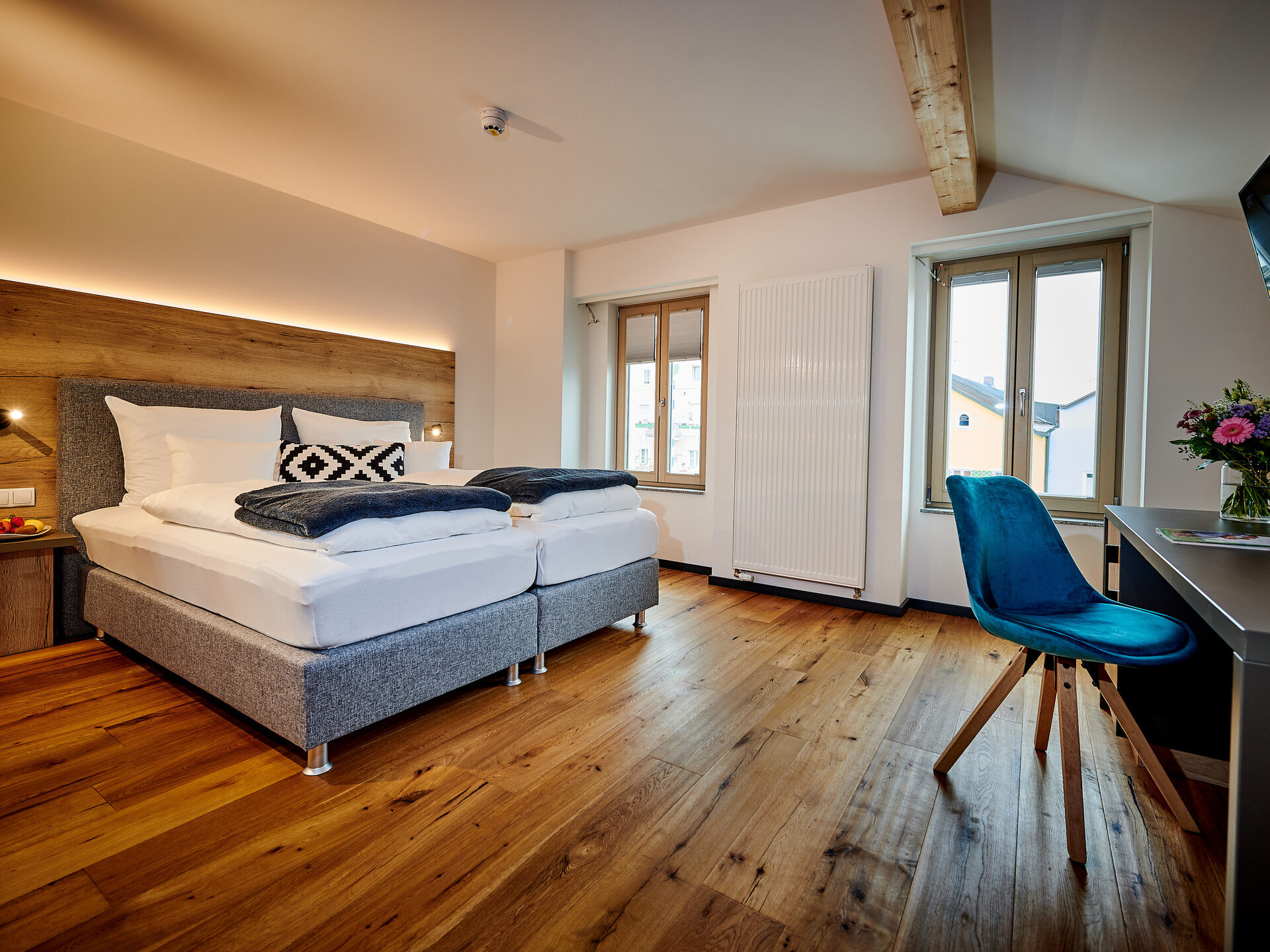 Das gemütliche Deluxe Doppelzimmer mit Holzakzenten und einem großen Fernseher.